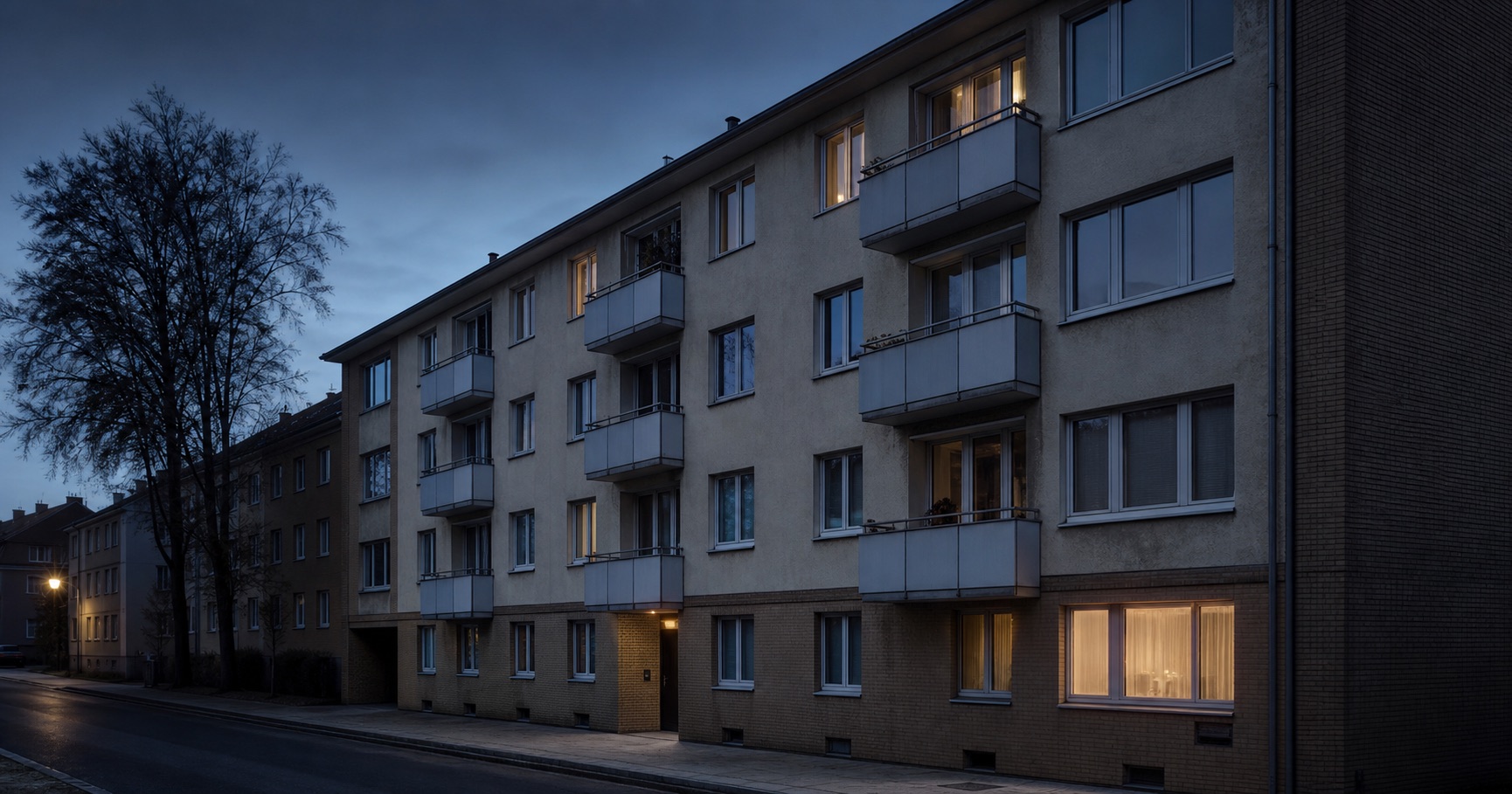 Existing multi-family residential building in a North Rhine-Westphalian city at dusk